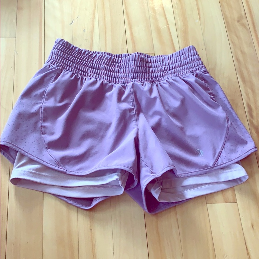 Dark purple athletic shorts.